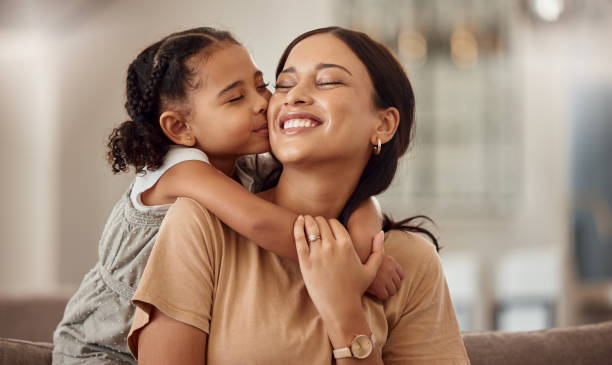 A happy pregnant woman smiling and holding her belly
